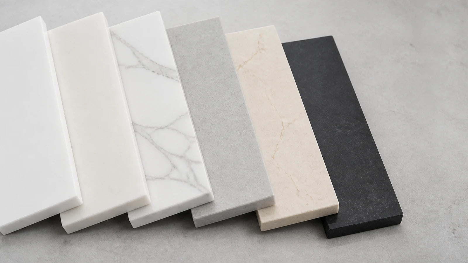 Quartz countertop color samples in white, veined white, gray, cream and black at the Aqua Kitchen showroom in Wayne NJ